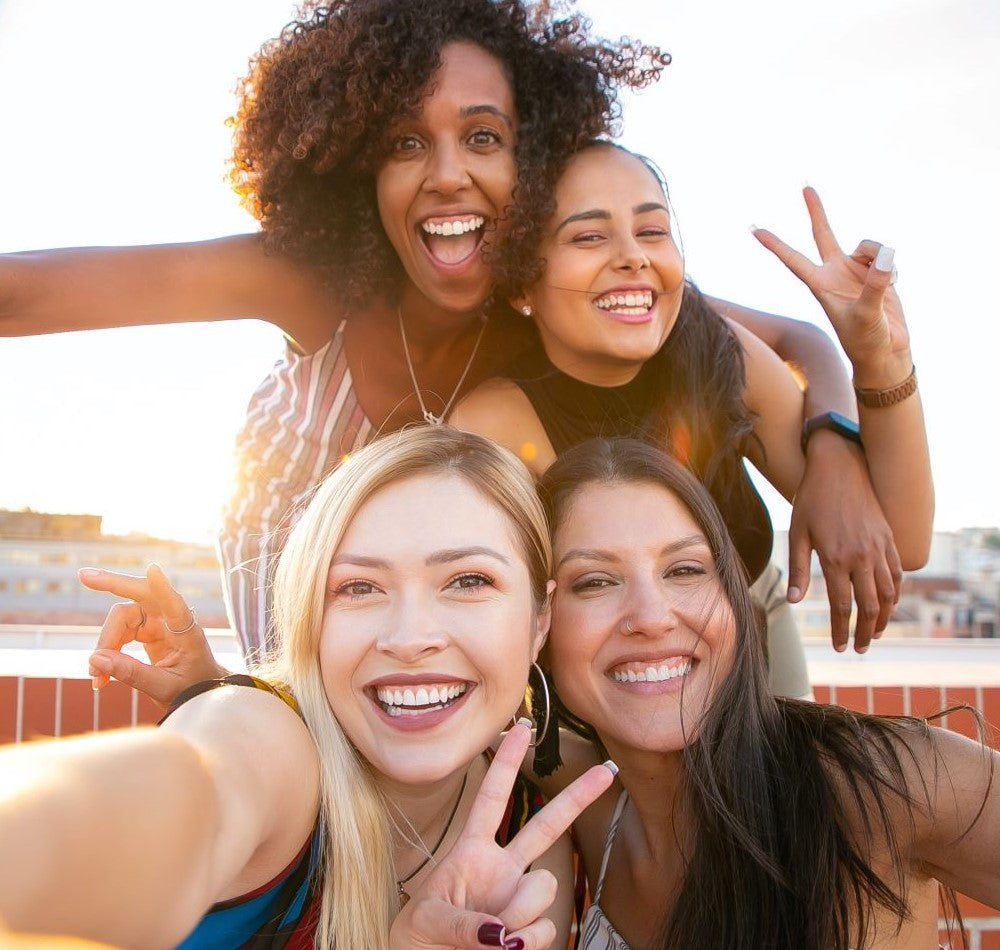 Four woman in a selfie on a roof_excited to use shine & grow